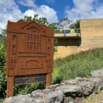 Eldridge Memorial and Metal Plaque set in in a flowery field
